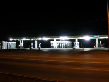 Gas station filling neighborhood with glare.