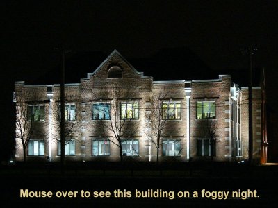 Professional building with exterior illuminated by metal halide up-lighting.